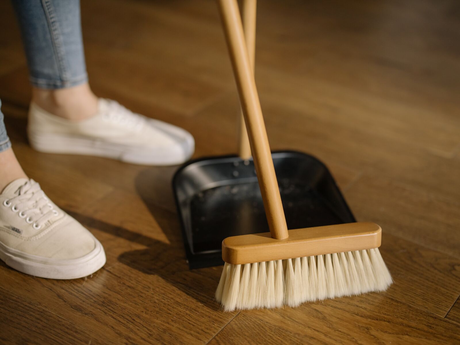 pexels-cottonbro-4108715 woman sweeping up floor with wooden brush