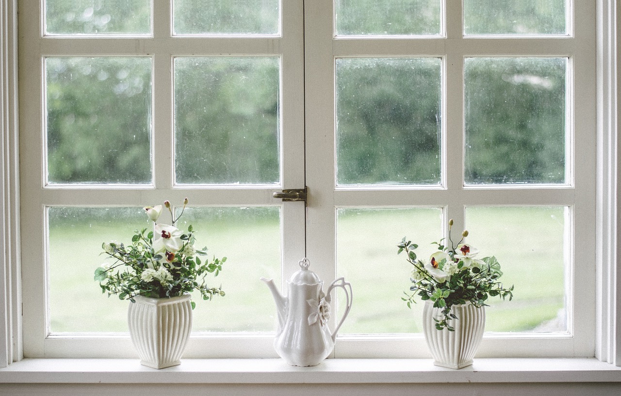 white window with vases and flowers